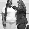 Photo courtesy of Jones College
Ronneyeka Duncan of Shubuta receives her nursing pin from Jones College
Practical Nursing Director as a symbol of officially accepting the role
of being a nurse.