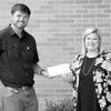 Submitted | The Wayne County News
Fant Carpenter (left) accepts a $25,000 check from Dixie Electric
Communication Specialist Amanda Mills as part of the Cooperative
Competes Grant.